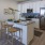 a kitchen with a large island and white cabinets