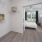 a laundry room with a washer dryer and shelves