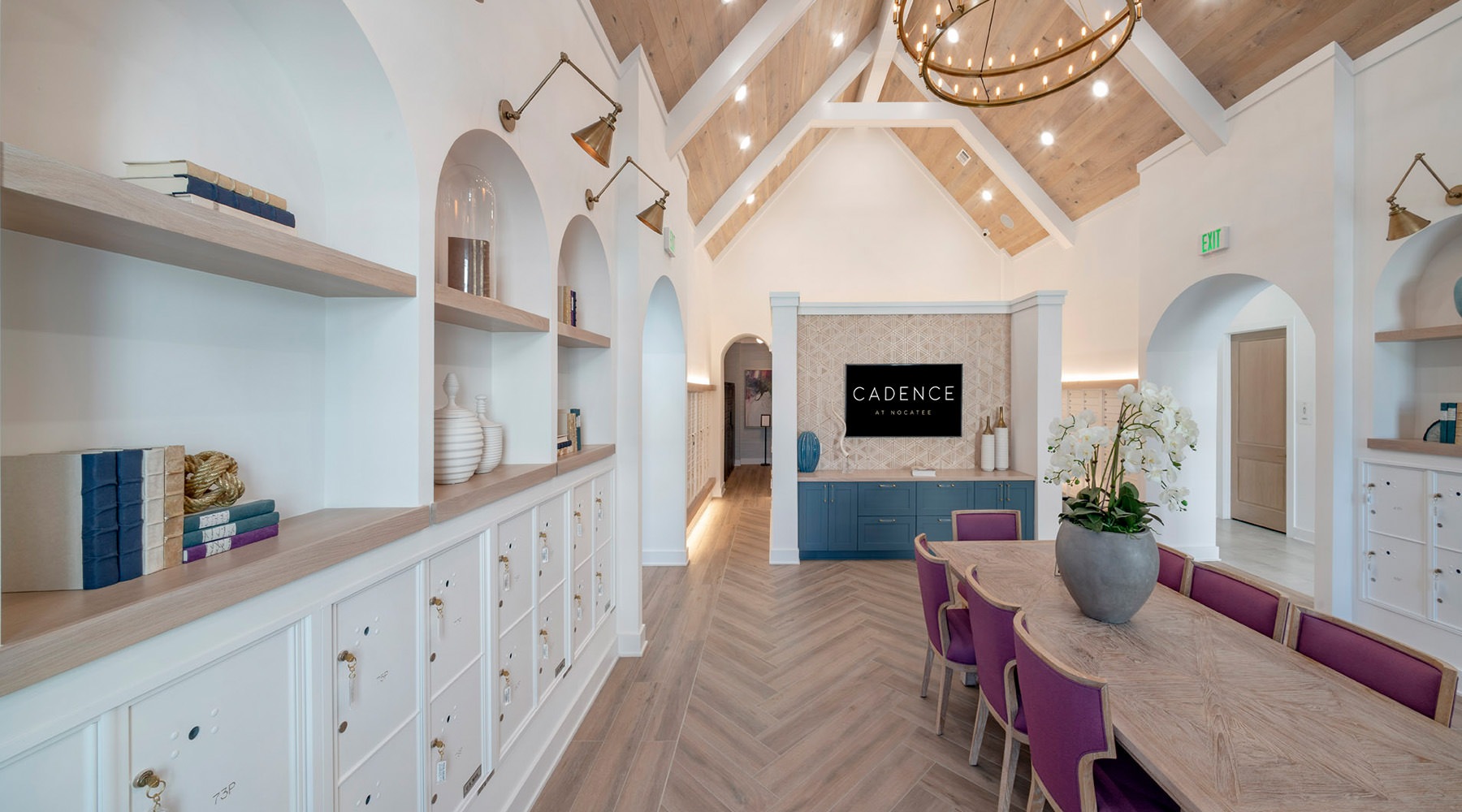 a room with a large table seating and bookshelves