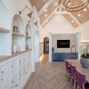 a room with a large table seating and bookshelves